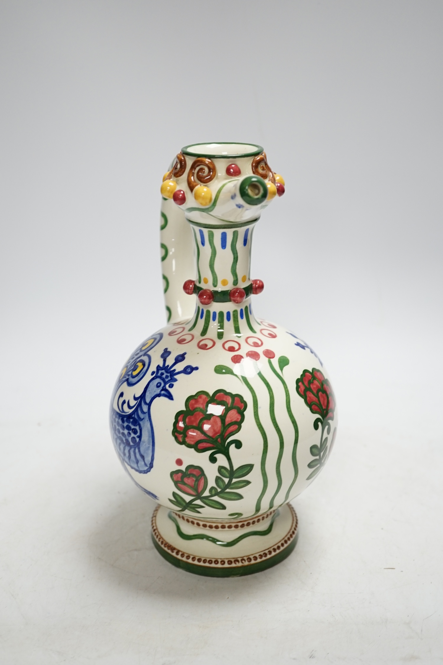 A Zsolnay jug or ewer decorated with peacocks and flowers, stamped ‘Zsolnay 830 and 07’ to the base, 24.5cm high